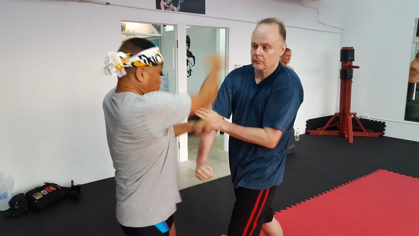CMLocals Chiang Mai Locals Emergency Self-Defence ED Visa two students practicing self-defence sparring in training gym